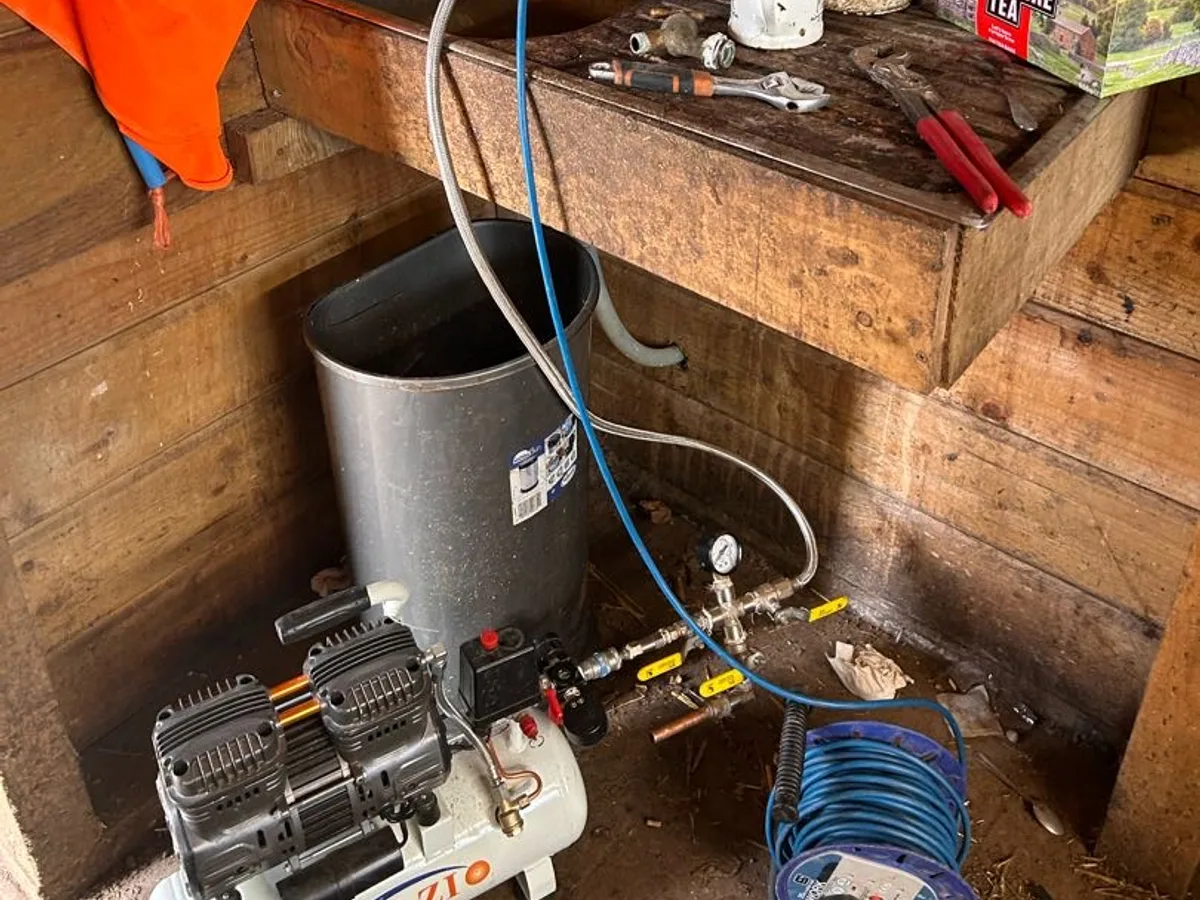 air compressor connected to farm building water feed during leak detection investigation