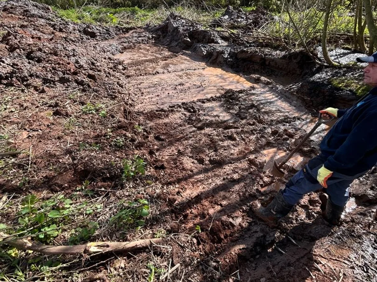 leak located at waterlogged excavated trench exposing saturated ground over underground mains