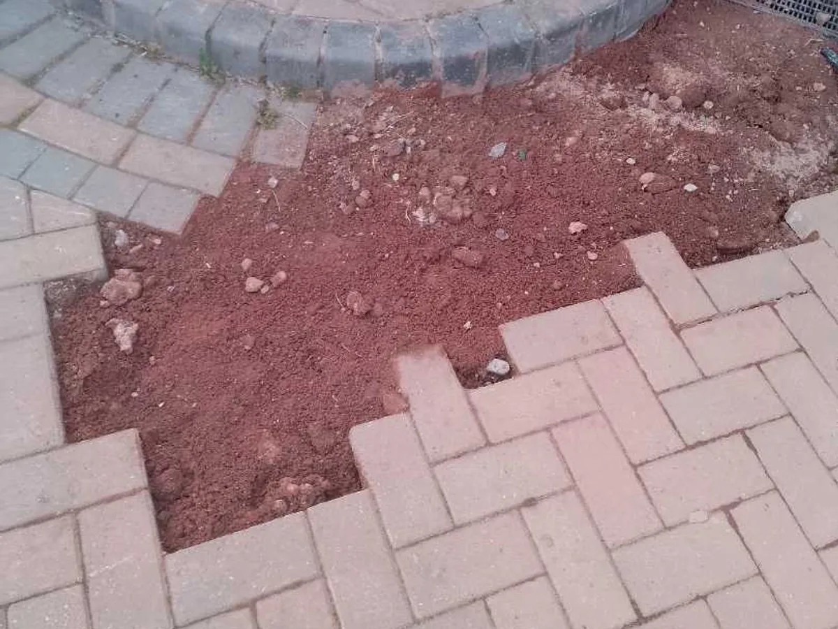 block-paved driveway with excavation backfilled after works completed