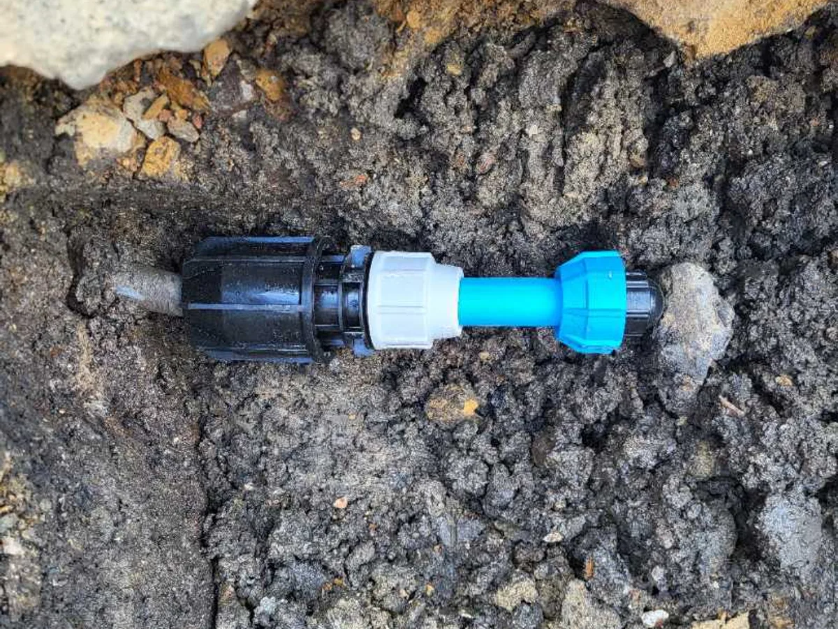 25mm MDPE blue pipe with universal coupling and end cap repair completed in excavated trench