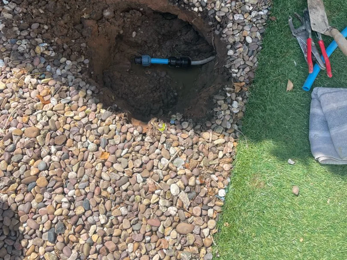 replacement Philmac transitional coupling installed in excavated pit as repair completed