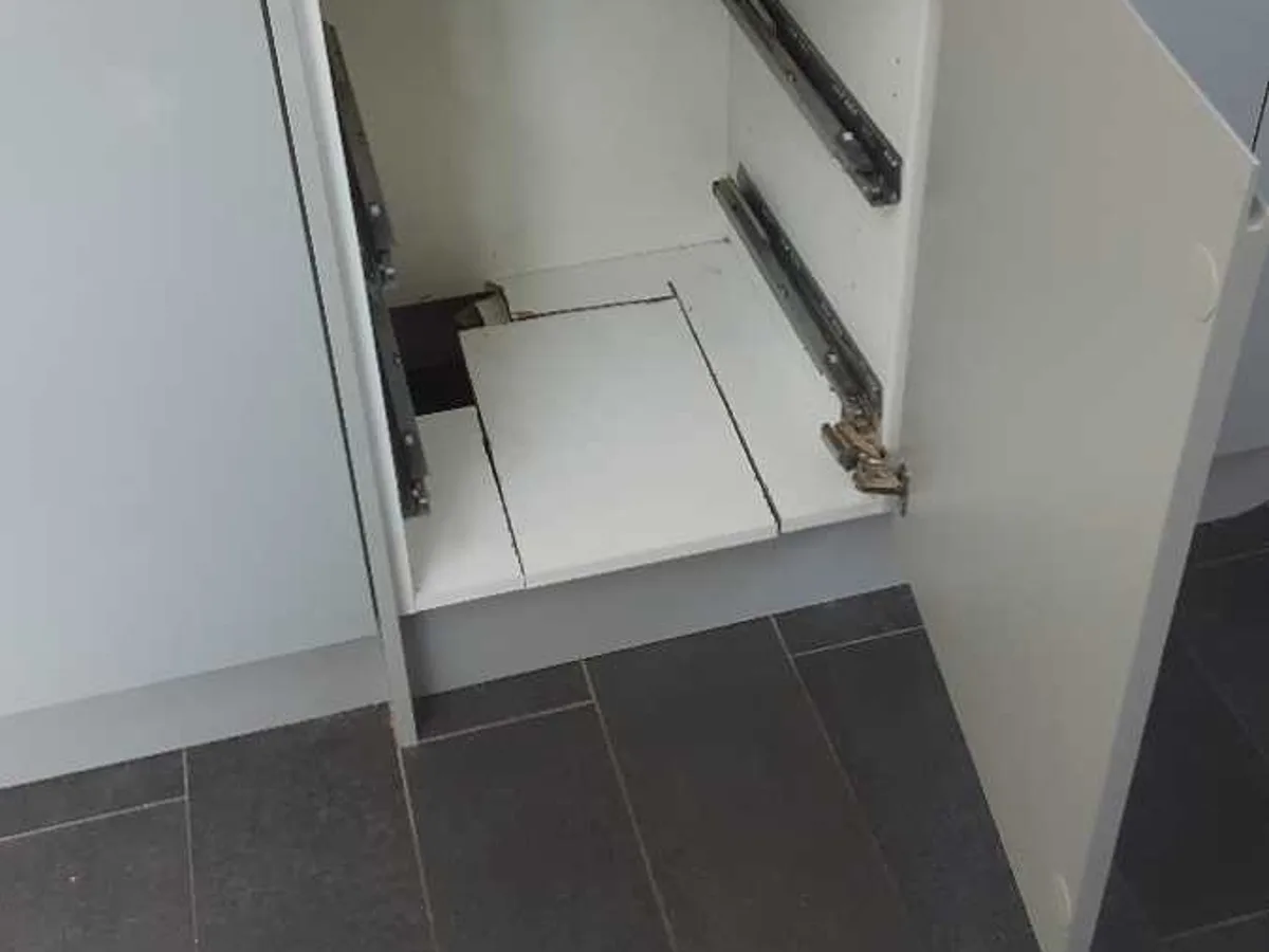 kitchen base unit door opened to access interior during leak detection survey
